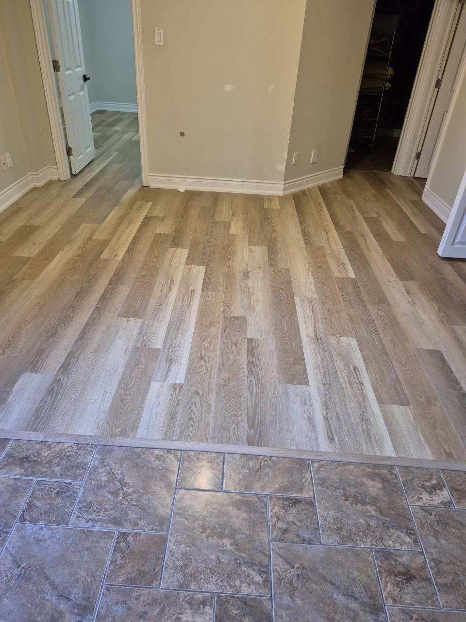 Hardwood flooring installation with tile transition